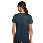 Person wearing a dark green athletic shirt with Nike logo on a white background
